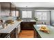 Kitchen featuring white countertops, dark wood cabinets, stainless appliances, and natural light from windows at 5285 S Jericho Way, Centennial, CO 80015