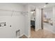 Functional laundry area with laminate floors leads to a bathroom and comfortable living area at 5285 S Jericho Way, Centennial, CO 80015