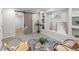 Relaxing living area with stylish barn door, recessed lights, decor shelves, and unique rattan chairs at 5285 S Jericho Way, Centennial, CO 80015