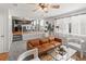 Inviting living room showcasing a brown leather sofa, stylish decor, and seamless transition to the modern kitchen at 5285 S Jericho Way, Centennial, CO 80015