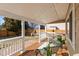 Covered patio with wood deck, white railing, outdoor seating, and view of fenced backyard at 5285 S Jericho Way, Centennial, CO 80015