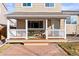 Relaxing covered porch with white railing and outdoor seating at 5285 S Jericho Way, Centennial, CO 80015