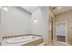 Relaxing bathroom featuring garden tub and walk-in shower at 7905 Schumaker Rd, Bennett, CO 80102