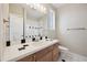 Bathroom with wood vanity, toilet and shower at 7905 Schumaker Rd, Bennett, CO 80102