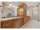 Elegant bathroom with wood cabinets and tile flooring at 7905 Schumaker Rd, Bennett, CO 80102