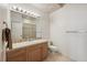 Clean bathroom with wood vanity and shower at 7905 Schumaker Rd, Bennett, CO 80102