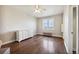 Bright bedroom featuring wood floors and a window view at 7905 Schumaker Rd, Bennett, CO 80102