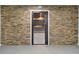 Gun room with stone wall and built-in shelving at 7905 Schumaker Rd, Bennett, CO 80102