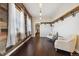 Charming sitting room with hardwood floors and rustic wall at 7905 Schumaker Rd, Bennett, CO 80102