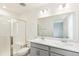 Bright bathroom with double sinks, a glass shower, and modern fixtures at 5780 N Killarney Way, Aurora, CO 80019