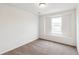 Cozy bedroom with neutral carpeting and a window, ideal for relaxation at 5780 N Killarney Way, Aurora, CO 80019