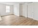 Bright bedroom featuring wood-look floors and a window offering plenty of natural light at 5780 N Killarney Way, Aurora, CO 80019