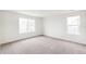 Well-lit bedroom with neutral carpeting and large windows providing ample natural light at 5780 N Killarney Way, Aurora, CO 80019