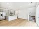 Modern kitchen with gray cabinets, stainless steel appliances, island with quartz countertop, and hardwood floors at 5780 N Killarney Way, Aurora, CO 80019