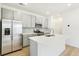Well-equipped kitchen with gray cabinets, stainless steel appliances, an island, and tile backsplash at 5780 N Killarney Way, Aurora, CO 80019