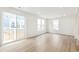 Open-concept living room with wood flooring, recessed lighting, and sliding door access to the backyard at 5780 N Killarney Way, Aurora, CO 80019