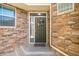 Charming front door made of stone with a welcome sign and stone details at 15063 E Crestridge Dr, Centennial, CO 80015