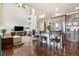 Spacious living room featuring an island with barstool seating adjacent to the fireplace at 15063 E Crestridge Dr, Centennial, CO 80015