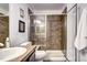 Bathroom with tiled shower and glass door, along with a tile countertop and sink at 800 Rockhurst Dr # D, Highlands Ranch, CO 80129