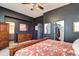 Bedroom with dark walls, dresser, walk-in closet, and doorway to bathroom at 800 Rockhurst Dr # D, Highlands Ranch, CO 80129