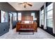 Spacious bedroom with dark accent wall and large windows providing natural light at 800 Rockhurst Dr # D, Highlands Ranch, CO 80129
