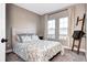 Cozy bedroom with a comfortable bed, window and curtains for natural light at 800 Rockhurst Dr # D, Highlands Ranch, CO 80129