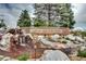 Stone Civic Green Park sign with waterfall feature surrounded by lush greenery at 800 Rockhurst Dr # D, Highlands Ranch, CO 80129
