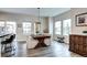 Bright dining area featuring a wooden table with upholstered chairs and abundant natural light at 800 Rockhurst Dr # D, Highlands Ranch, CO 80129