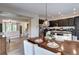 Inviting dining area with a dark wood table, chandelier, and seamless flow into the living spaces and kitchen at 800 Rockhurst Dr # D, Highlands Ranch, CO 80129