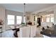 Open concept kitchen and dining room with a modern light fixture and wood-look flooring at 800 Rockhurst Dr # D, Highlands Ranch, CO 80129
