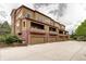 Exterior view of townhomes with brick accents and garage access at 800 Rockhurst Dr # D, Highlands Ranch, CO 80129