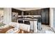 Modern kitchen with dark cabinets, granite countertops, and a stainless-steel refrigerator at 800 Rockhurst Dr # D, Highlands Ranch, CO 80129