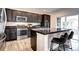 Contemporary kitchen with a peninsula bar, stainless steel appliances, and a sliding door at 800 Rockhurst Dr # D, Highlands Ranch, CO 80129