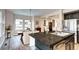 Bright open concept kitchen and dining room with granite countertops and wood-look floors at 800 Rockhurst Dr # D, Highlands Ranch, CO 80129
