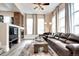 Cozy living room with a brick fireplace, large windows, and a comfortable leather couch at 800 Rockhurst Dr # D, Highlands Ranch, CO 80129