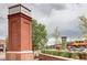 Brick entrance sign to Town Center, clock tower visible in the background at 800 Rockhurst Dr # D, Highlands Ranch, CO 80129