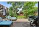 Spacious backyard with patio furniture, green grass, shed, and privacy fence at 361 Elati St, Denver, CO 80223