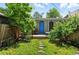 A backyard space with a small deck, grassy area, and a walkway of stone steps at 361 Elati St, Denver, CO 80223