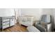 Bright Bedroom features a crib, changing table, and comfortable chair at 361 Elati St, Denver, CO 80223