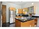 Modern kitchen with stainless steel appliances, unique flooring, and ample counter space at 361 Elati St, Denver, CO 80223