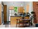 Bright kitchen with stainless steel appliances, light wood cabinets, and a dining area at 361 Elati St, Denver, CO 80223