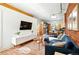 Bright living room featuring exposed brick, hardwood floors, and stylish modern furnishings at 361 Elati St, Denver, CO 80223