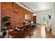 Open-concept living and dining area features exposed brick, wood floors, and modern furniture at 361 Elati St, Denver, CO 80223