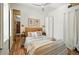 Stylishly staged main bedroom boasts modern decor, wood flooring, and a ceiling fan at 361 Elati St, Denver, CO 80223