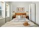 Bright and airy main bedroom with neutral tones, warm wood accents, and large windows at 361 Elati St, Denver, CO 80223