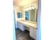 A view of the bathroom with double sinks, large vanity, and a view to the walk-in closet at 7777 S Biloxi Way, Aurora, CO 80016