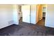 A view of a cozy bedroom with a large doorway leading to the kitchen area at 7777 S Biloxi Way, Aurora, CO 80016