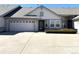 Charming single-story home with a two-car garage, stone accents, a well-maintained lawn and a paved driveway at 7777 S Biloxi Way, Aurora, CO 80016