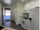 A well-organized kitchen with white appliances conveniently opens to the garage area for easy access and unloading at 7777 S Biloxi Way, Aurora, CO 80016