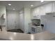 Efficient kitchen with white appliances, neutral countertops, and abundant storage, with easy access to both garage and the living area at 7777 S Biloxi Way, Aurora, CO 80016